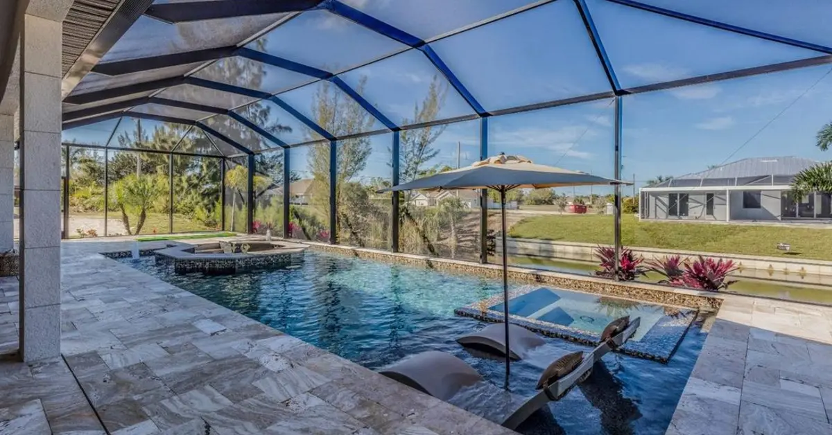 Clean paver pool deck inside a screened Florida enclosure
